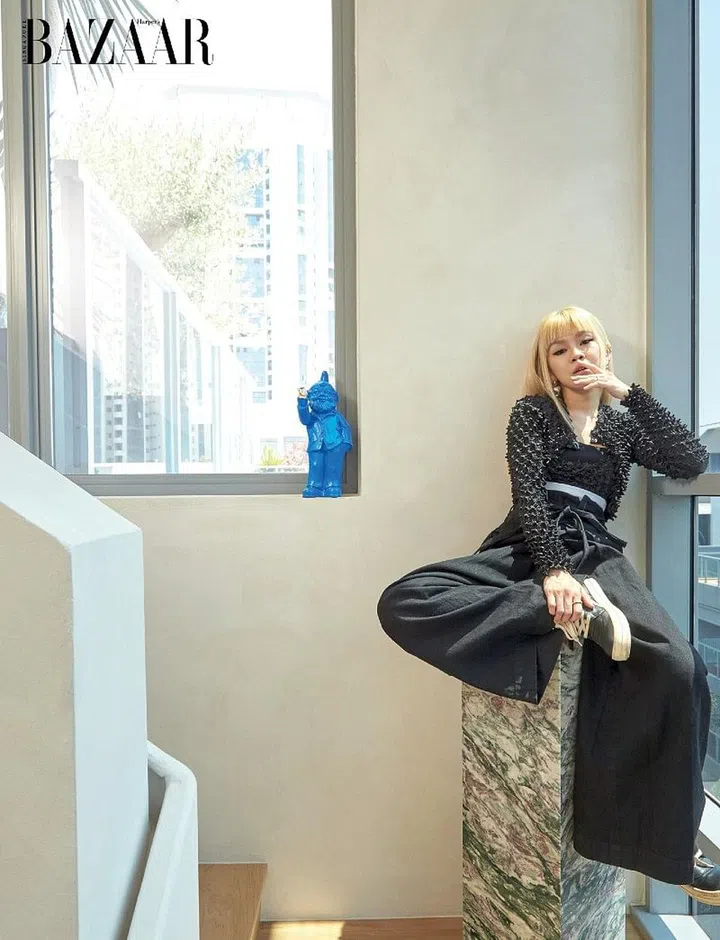 Chng in her own Alexander Wang jacket and top, Mihara Yasuhiro trousers and Rick Owens shoes teamed with her Chanel earrings and Chrome Hearts rings; beside her, a gnome she
picked up during her
Fashion Week travels.