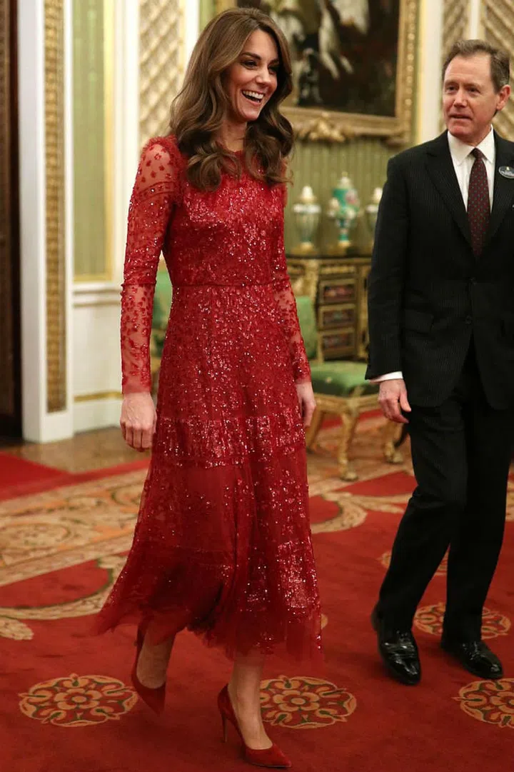 The Duchess of Cambridge stunned in a red sequin dress by Needle and Thread at Prince William's first solo Buckingham Palace reception on behalf of Queen Elizabeth, in honor of the UK-Africa Investment Summit. She finished off the look with matching red pumps from Gianvito Rossi and a box clutch bag.