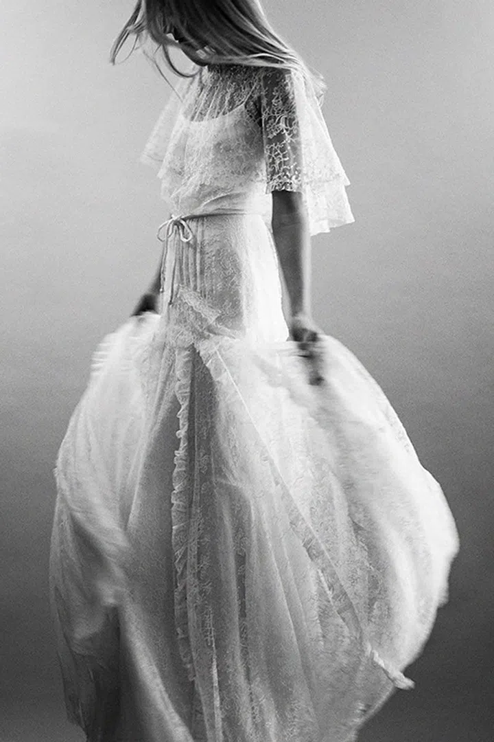 When thinking about classic French design houses who have set the pace in the world of exquisite fabric choices, design innovation and quality of construction, like Dior, Valentino and Nina Ricci (just to name a few), a certain standard comes to mind...and it's high–very high. That level of expectation is consistently in the back of designer Celestina Agostino's mind, and she credits the brilliance of Europe's famed houses for keeping her on her toes. A Paris-based atelier is a good start, giving her access to the laces and mills required for the highest quality product. But unlike Couture, Agostino's work is truly wearable and serves as a delicate, feminine canvas for styling with her Chantilly boleros and cool versions of bridal belts.