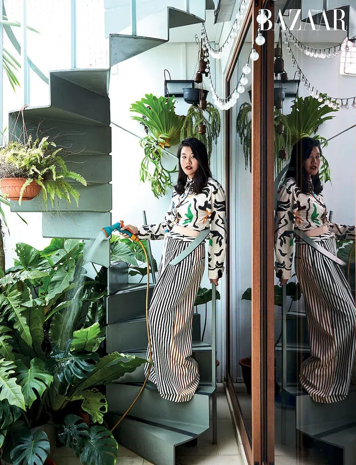 Tending to her plants, Tan wears a Zara top, Partow trousers via Net-a-Porter and Converse sneakers.