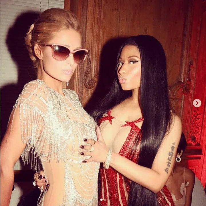 Who said you can’t wear pink sunnies with your red carpet naked dress? Photo: @parishilton 