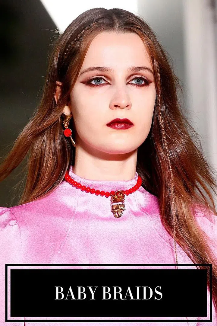 In this world nothing can be said to be certain, except death, taxes, and some kind of braid at Valentino. But instead of the long, romantic braids we've seen at so many season's past—the hair was parted down the middle, and two micro braids were weaved along the hairline. It had a Coachella-like quality, adding visual interest to hair that would otherwise just be down. When baby braids popped up at two other shows, it became clear that good trends sometimes come in small packages.