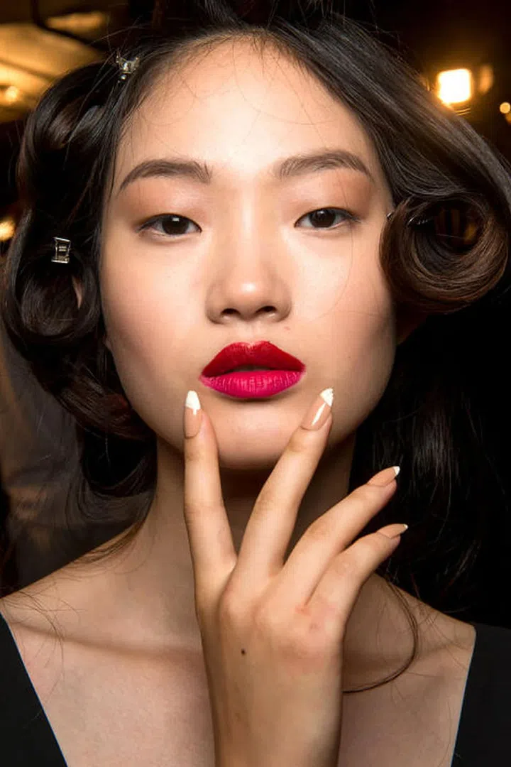 Two beauty references we will never stop loving? Miami in the '80s and Scarface. Those were the inspirations backstage at Cushnie et Ochs' spring 2017 show, where the dresses were slit up-to-there and the lips took colourblocking to a whole new level. On the top lip, makeup artists swiped on a cherry-red matte lipstick (MAC in Perfect Score),while the bottom lip got a coat of Relentlessly Red (a confusing name for a matte, hot pink shade). Just one word of advice if you try this at home: don't smack your lips together. Otherwise, the colourblocking effect just becomes a colour.