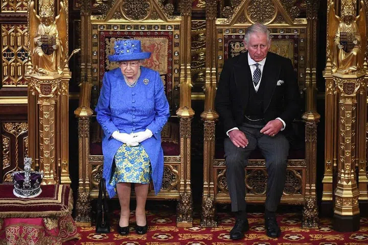 Queen Elizabeth II and her son Prince Charles arrive in the House of Lords at Houses of Parliament in London.