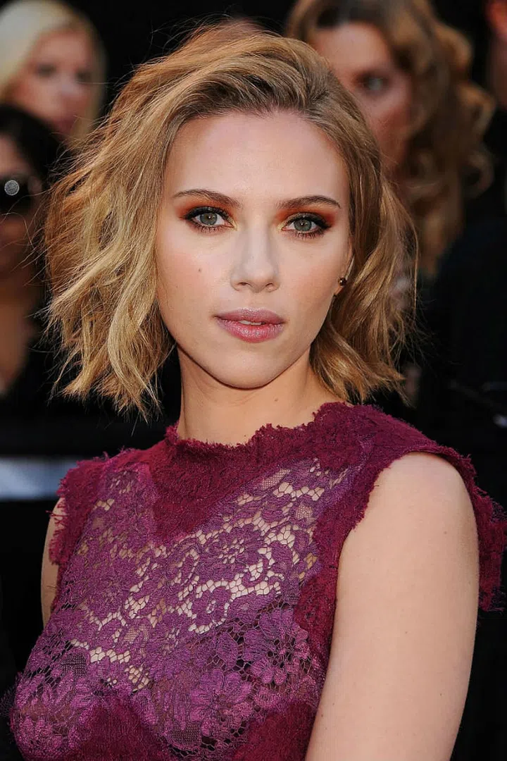 Use a one-inch curling rod and plenty of texturizing spray to create Scarlett Johansson's wavy 'do.