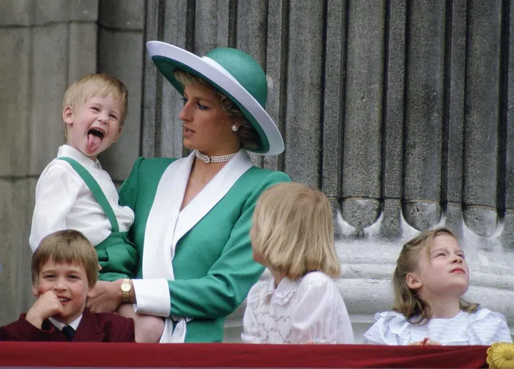 Prince Harry, 3, sticks his tongue out during the Trooping the Colour ceremony from the balcony of Buckingham Palace.