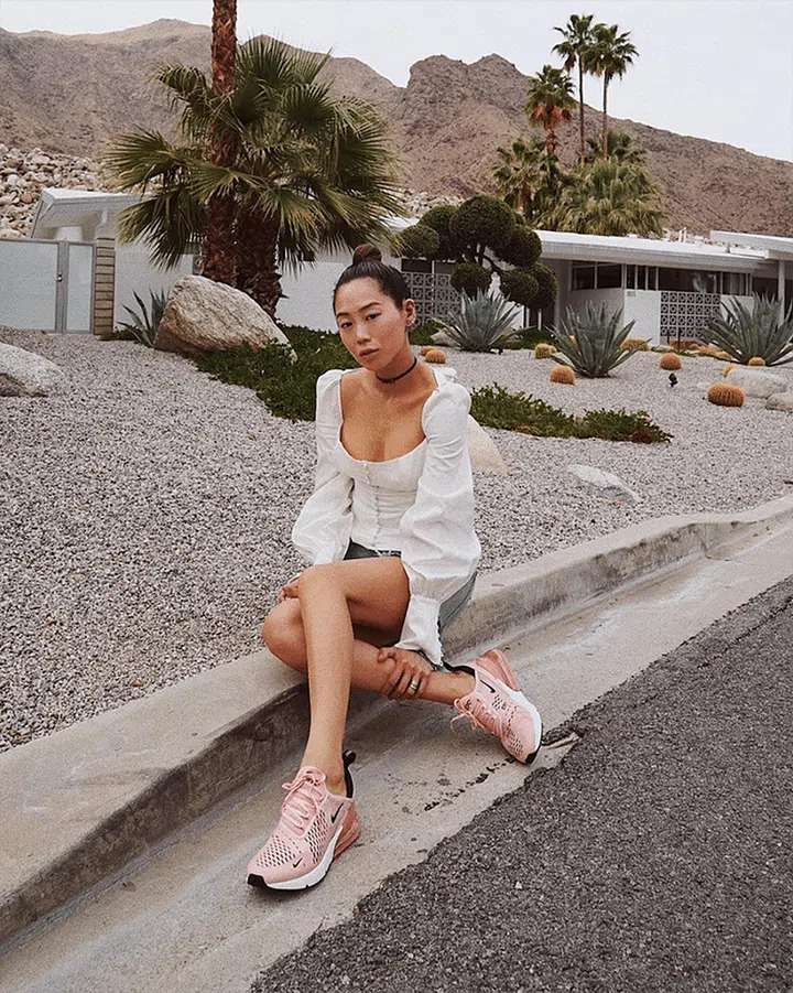 Proving the reigning white top of Instagram has legs on the festival circuit is celeb influencer Aimee Song. She pairs hers with pink kicks for added fun.

Shop it: Capulet top, $88, revolve.com.