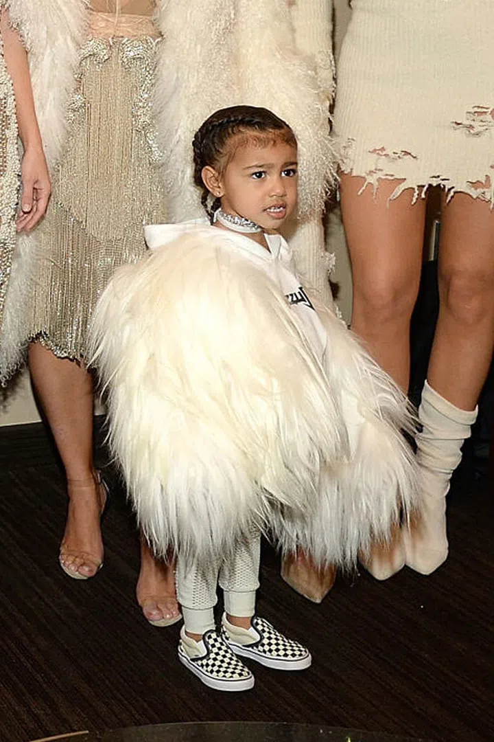 North steals the show from the Kardashian-Jenner clan at Yeezy Season 3 show in a custom Yeezy x Balmain fur coat, Yeezus sweatshirt and Vans. Photo: Getty