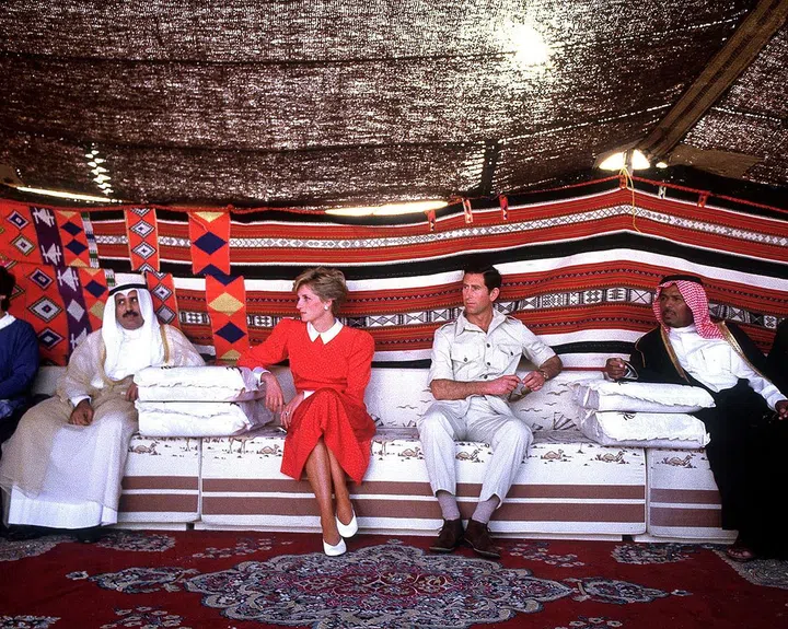 Watching a camel race in the desert near Doha during an official visit to Qatar with Prince Charles. Photo: Getty