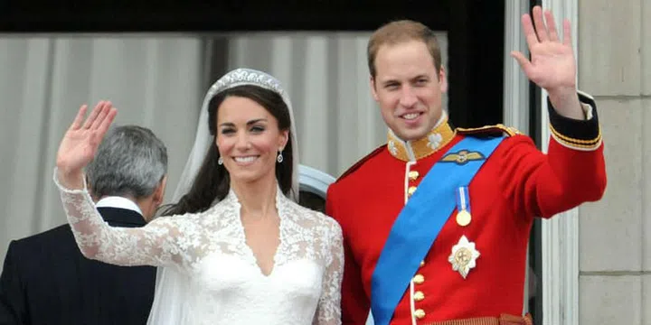The newly-married couple waves to the thousands of loyal fans.Photo: Getty

