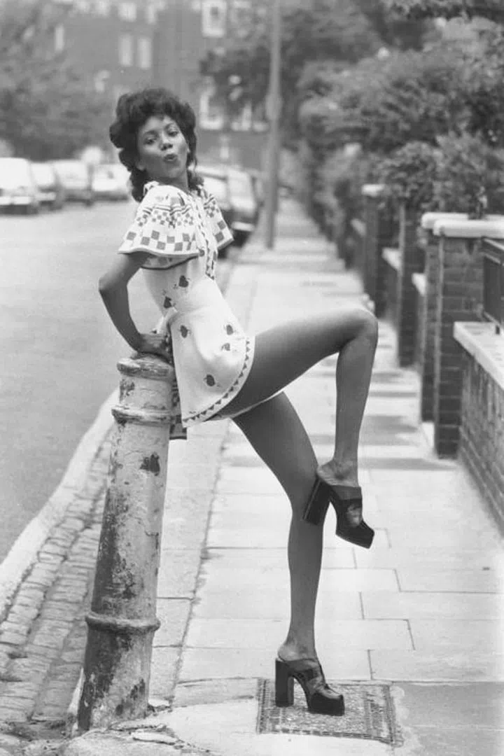 The '70s are still alive this summer, embrace them in the form of an off-the-shoulder ruffle dress paired with platform sandals.