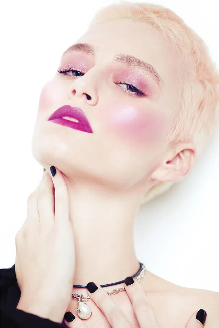 If the spring/summer 2017 runways of Chanel and Kenzo are any indication, it’s that draping—where blush is used in place of contour and highlight kits—is the new go-to when defining the cheeks, brow bones and even jawline. To slim and elongate rounder face shapes, dab a powder blusher with a satiny texture (try Make Up For Ever’s Artist Shadow Eyeshadow and Powder Blush in S920 Violet) just under the apples of your cheeks to create the illusion of a more angular face. Sweep the same shade all over the lids and match your lips with Tarte’s Tarteist Creamy Matte Lip Paint in Yaassss, $32, for a dreamy and modern take. 
 
Necklace, Céline. Dress, Versace