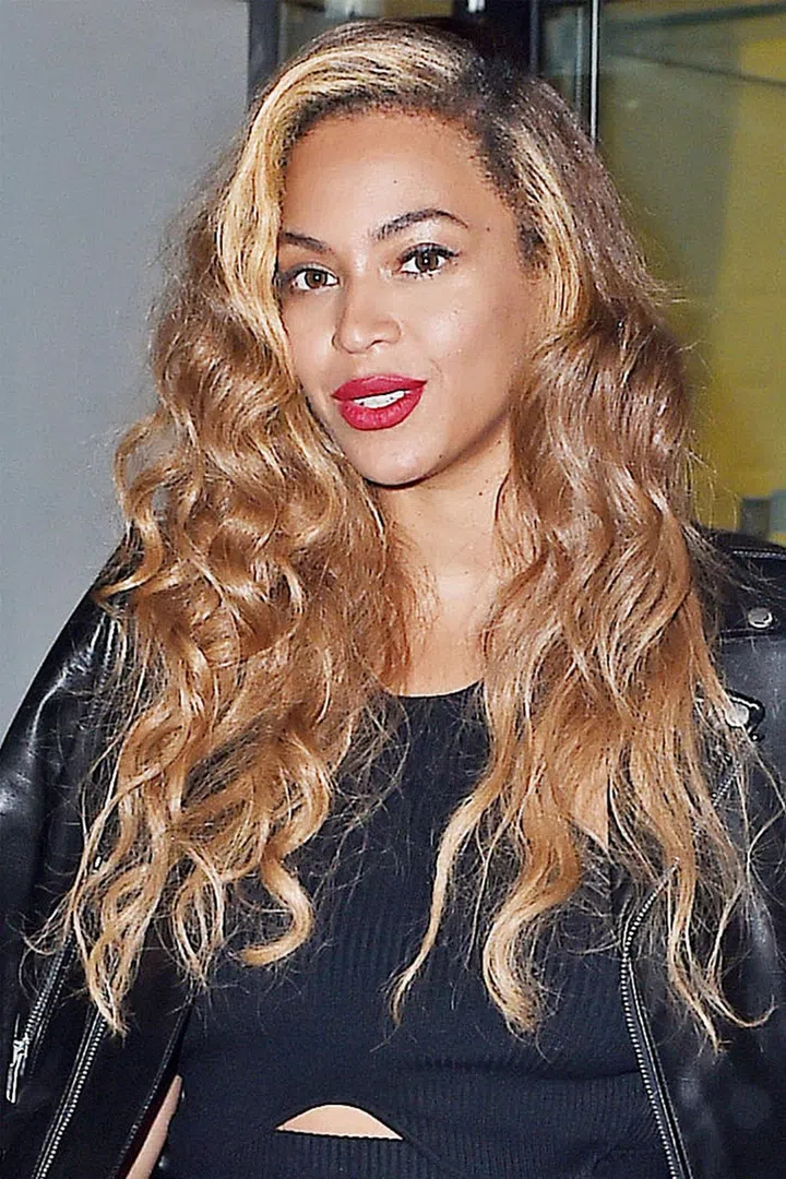 Beyonce opts for a bleach blonde streak to frame her face and balances it out with honey blonde strands.