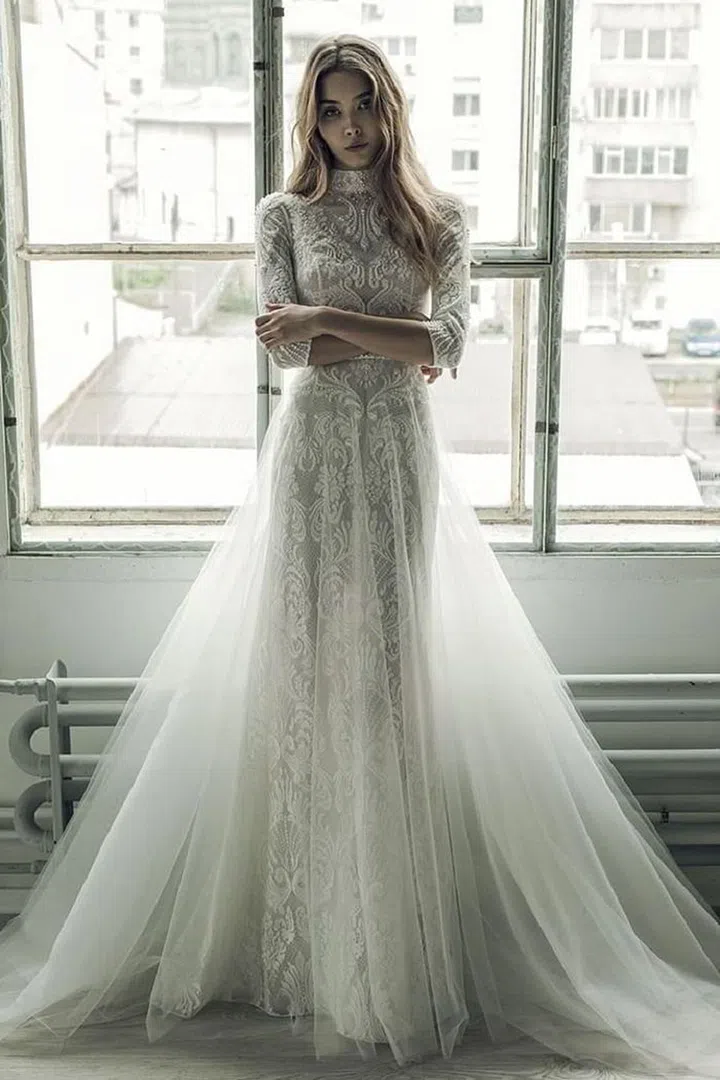 A princess bride meets a modern day free spirit in all of Ersa Atelier's designs. In their Bucharest-based atelier, the story of a gown "always begins with Once Upon A Time...but takes place in present tense." The sister design duo, Gabriela and Cristina Antonescu, came up through the fashion ranks in Romania side by side, apprenticing for seven years before opening their atelier. Romantic details like sheer overskirts, mock necklines, sheer insets and subtle uses of color set this line apart from its counterparts.