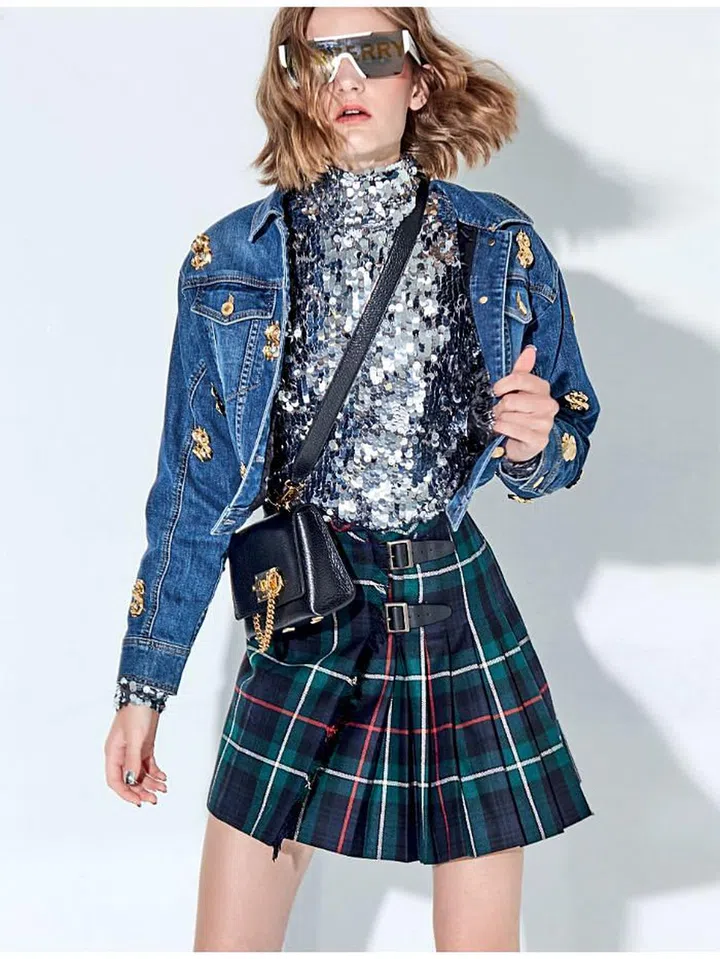 Sunglasses, Burberry. Jacket,
Moschino. Skirt, Ralph Lauren.
Bag, Salvatore Ferragamo. Turtleneck, H&amp;M Studio.