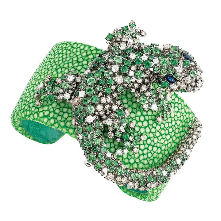 The ancient Egyptians and Greeks considered lizards as symbols of good fortune and intelligence. Detach  Damiani’s white gold, sapphire, tsvaorite, brown and white diamond Masterpiece Animalia Gecko brooch from its galuchat bracelet and pin it onto a colourful scarf to wear for an extra dose of good luck.