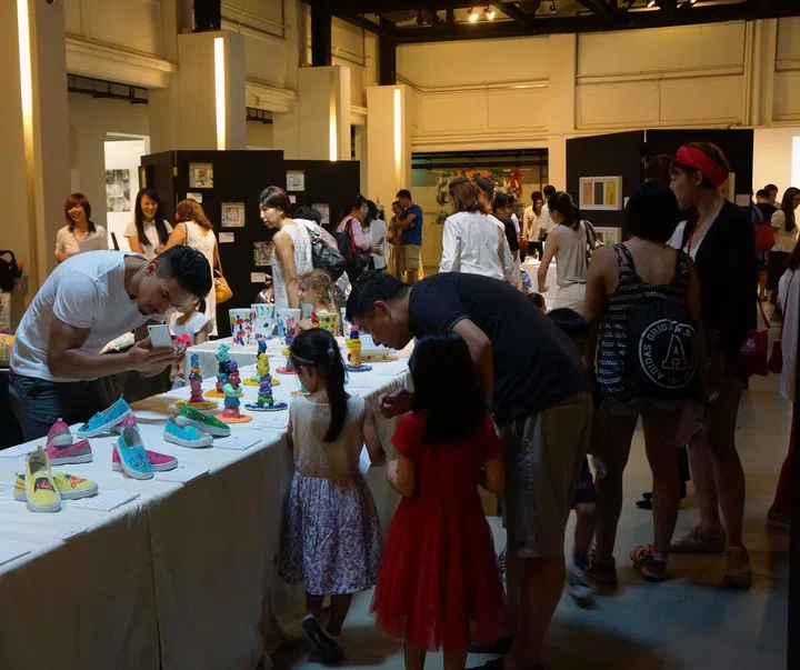 Adults and Children are intrigued by the different artistic creations  displayed during the exhibition