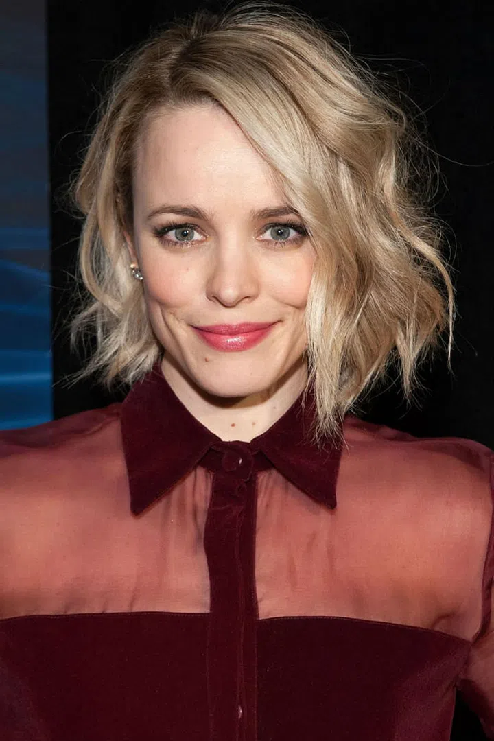 To achieve Rachel McAdams' chin-length style, wrap random pieces of hair around a curling rod.