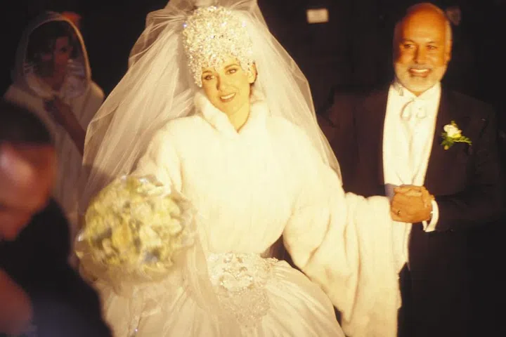The iconic singer kicked off her marriage to her manager Rene Angélil on December 17, 1994 wearing a breathtaking Mirella and Steve Gentile gown featuring long sleeves and a 20-foot train. The (literal) crowning glory of the look that's more divisive than the dress itself: a seven-pound headpiece.