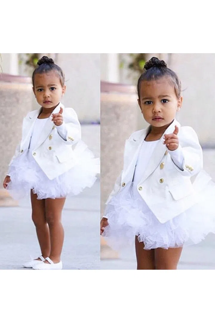 Kim Kardashian shares a photo of North West's ballet ensemble—an all-white Balmain look—on Instagram.