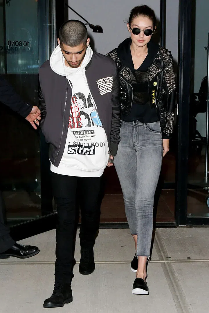 Gigi Hadid left her NYC apartment with boyfriend Zayn Malik, dressed in a studded Burberry leather jacket, gray jeans and slip-on sneakers. Photo: AKM-GSI