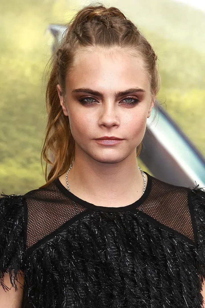 Delevingne adds a twist to the staid ponytail with corn-rowed braids extending back from the hairline.