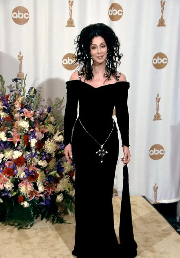 Have you ever seen anyone wear a hip chain with a giant cross? Didn't think so. Cher entered the new millennium unveiling another new look at the Oscars. this time, it was darker and there was even Medusa-inspired hair included and of course, she totally nailed it. Photo: Getty 