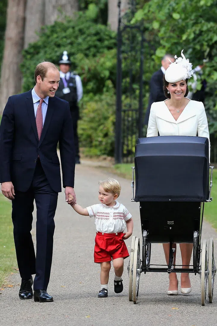 Duchess Kate pushes Princess Charlotte in a stroller as her family arrives at the Church of St. Mary Magdalene for Charlotte's christening.
Photo: Getty
