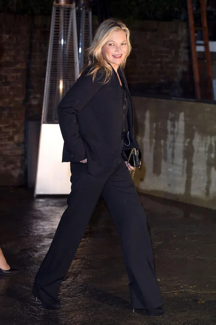 Kate Moss scraps her signature skinnies for a wide-leg suit, exuding a rock 'n' roll 70s appeal. Photo: Getty 