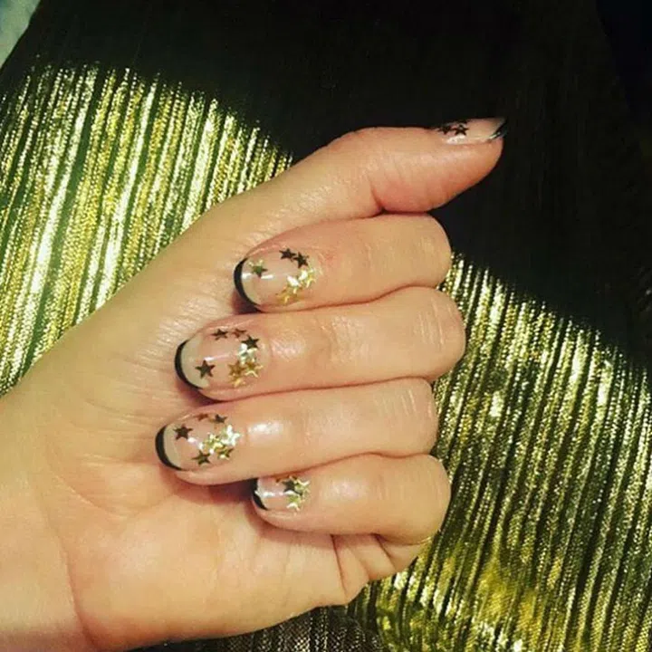 Love this look! Apply a clear top coat, paint a thin black line at the tip, then cluster gold stars randomly around each nail.
@valleynyc 