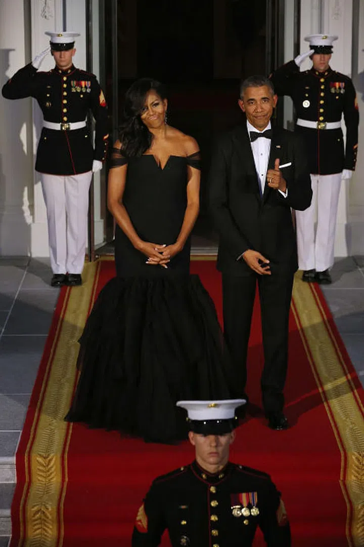 Quite possible one of the First Lady's most iconic looks, the President couldn't help but give his wife a thumbs up for this stunning black Vera Wang gown.