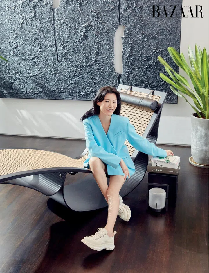 Wu wears a blazer and skirt, from GANNI at Net-a-Porter, and Alexander McQueen sneakers as she rests on an Oscar Niemeyer chair. Photo: Gan