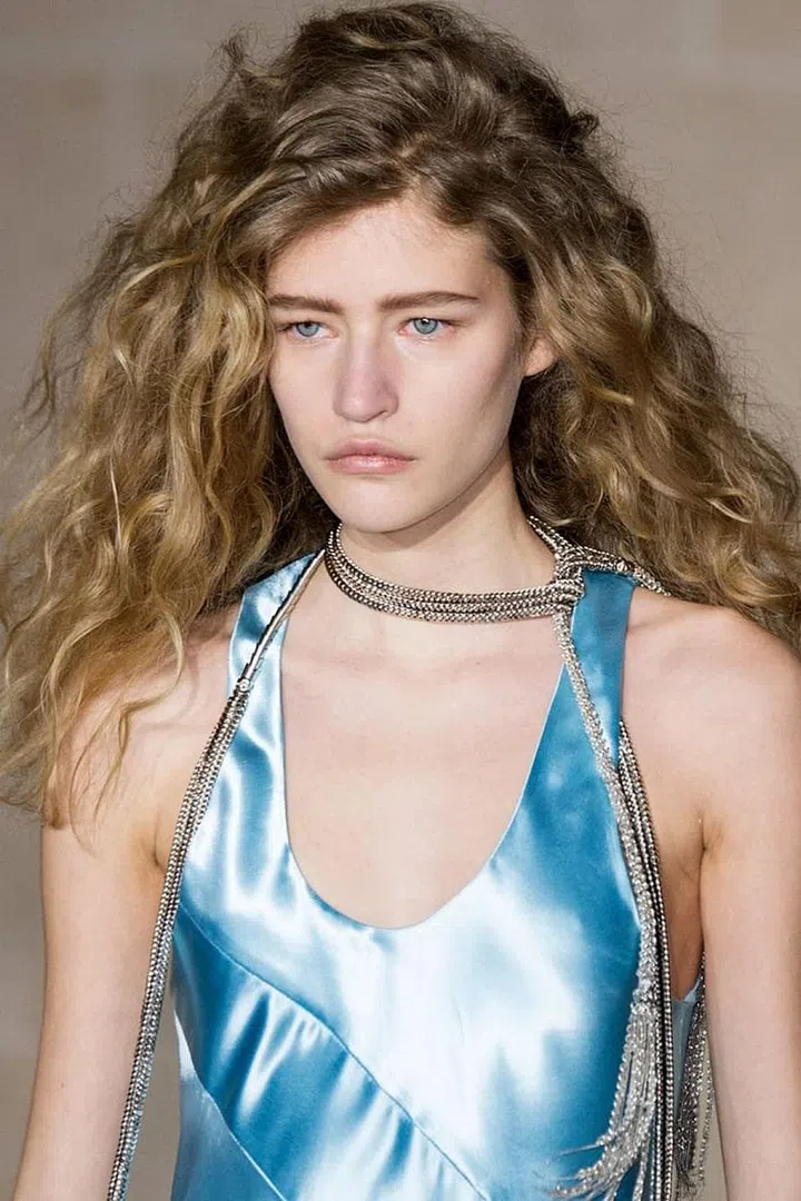 At Louis Vuitton, hairstylists coaxed big, natural curls out of the models' own hair texture.
