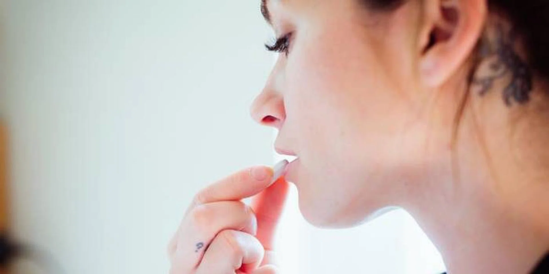 woman eating immunity-boosting supplement feature image