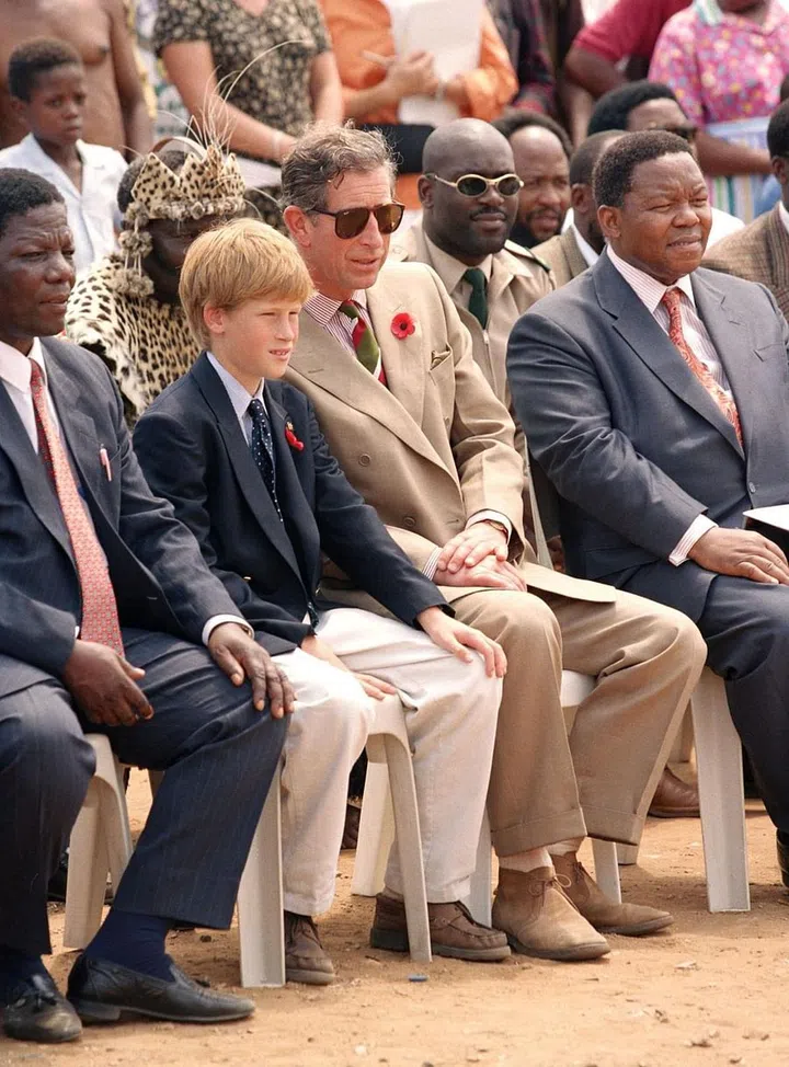 Prince Harry, 13, and Prince Charles visit a Zulu village in South Africa.