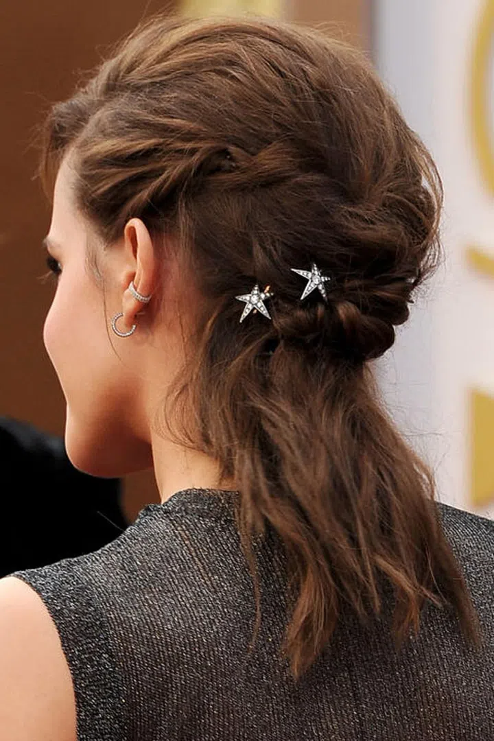 There's a lot going on here: rumpled and textured waves, braids and twists, but it's the star accessories that pull it all together.