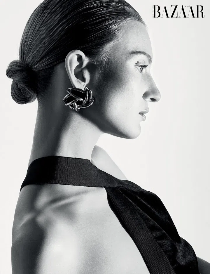 Bodysuit; earrings, Saint Laurent by Anthony Vaccarello.