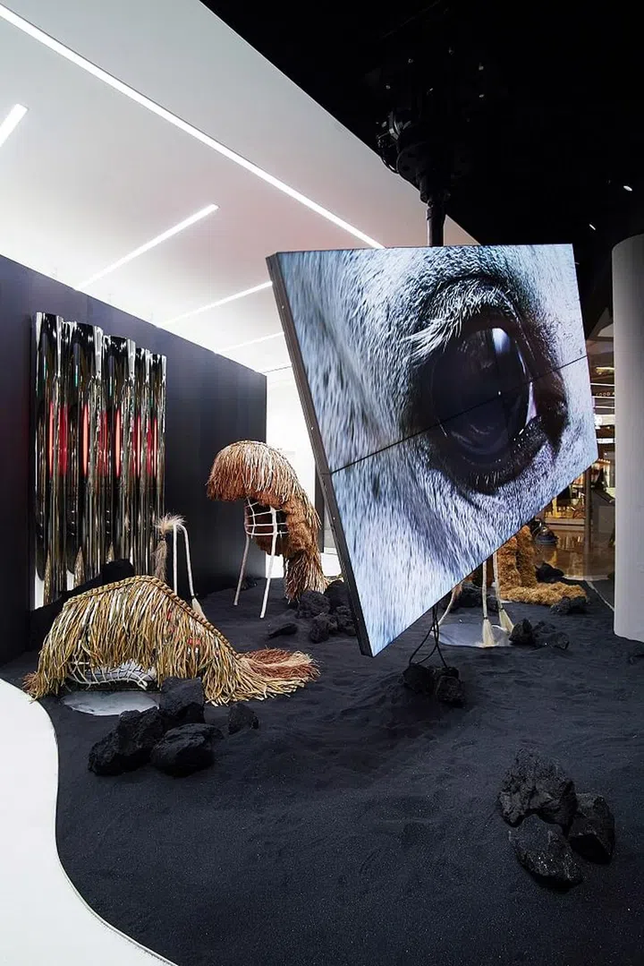 The "creatures" in the background represent people and how they have become paranoid and overprotective in light of the environmental tragedy that has befallen on Earth. The kinetic movements show how inhuman they have become and the straw-like outer layer is a shield that these people have draped on themselves for protection against the elements. They roam around Earth, in perpetual search of data. 