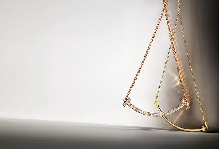 From left: Tiffany T medium smile pendant in 18k rose gold with diamonds; Tiffany T smile pendant in yellow gold (small). (Photo: Tiffany & Co.)