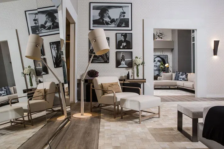 Luciana's light-filled space of warm beiges and browns features a quilted bed frame and hand-stitched chairs. Her space also displays iconic black and white photographs of the noted fashion designer, further solidifying the pairing.
