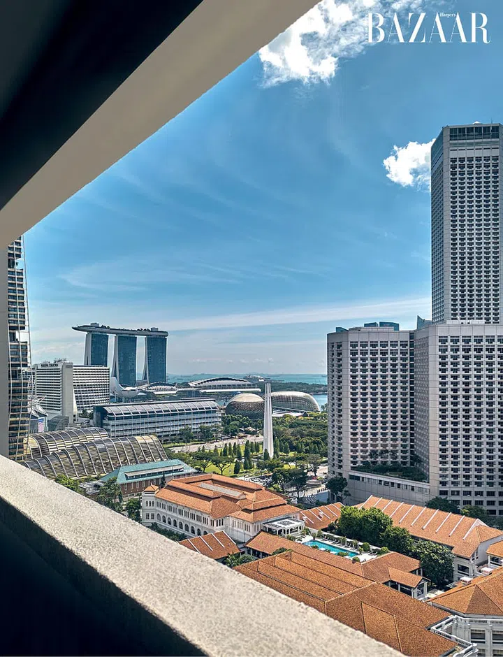 The stunning view from his high-floor apartment overlooking the Raffles Hotel and Marina Bay area.