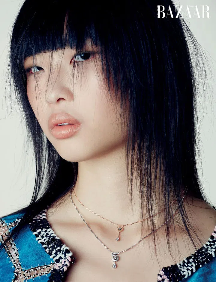 Beige gold and diamond Extrait de N°5 necklace; white gold and diamond Eternal N°5 necklace, Chanel. Jacket, Chanel.