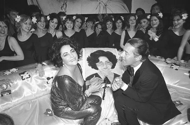 Elizabeth Taylor celebrates her 46th birthday at a Studio 54 party with designer Halston. Photo: Getty