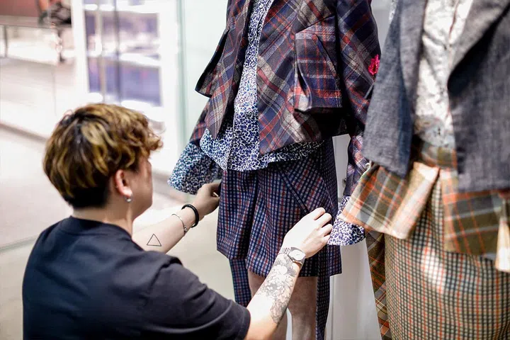 Finalist Andrew Low putting the final touches on his clothes. 