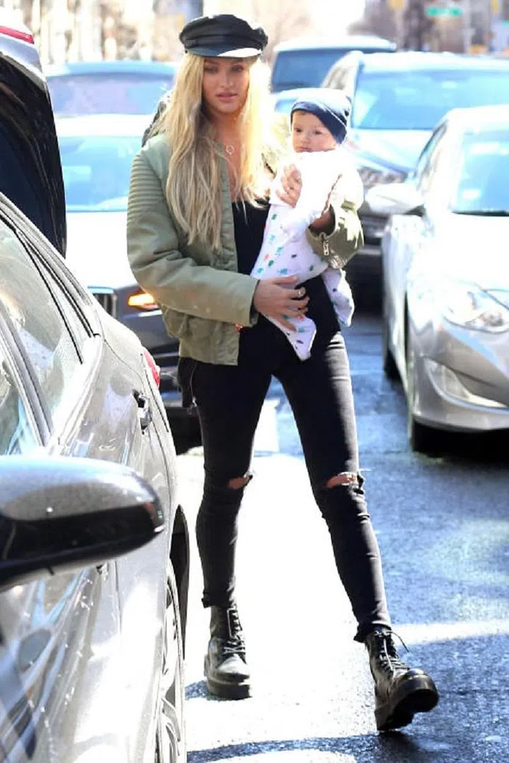 Candice Swanepoel proves she's not a regular mom, she's a cool mom, using her leather baker boy to elevate her jeans and t-shirt routine. 