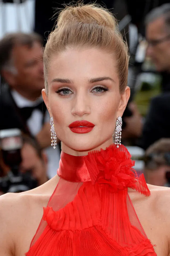 The style: A sleek, high bun with striking red lips made Rosie Huntington-Whiteley stand out on the red carpet. Photo: Getty 