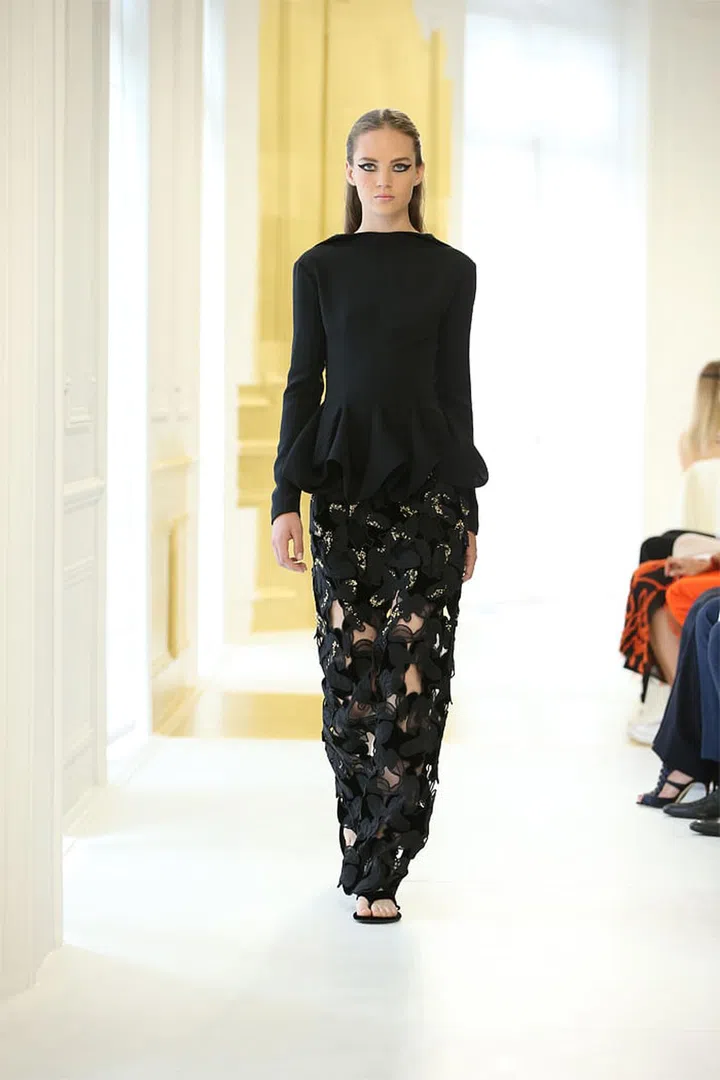 Black tucked silk crêpe top over a black organza guipure and velvet skirt with gold sequin embroidery. Photo: Dior
