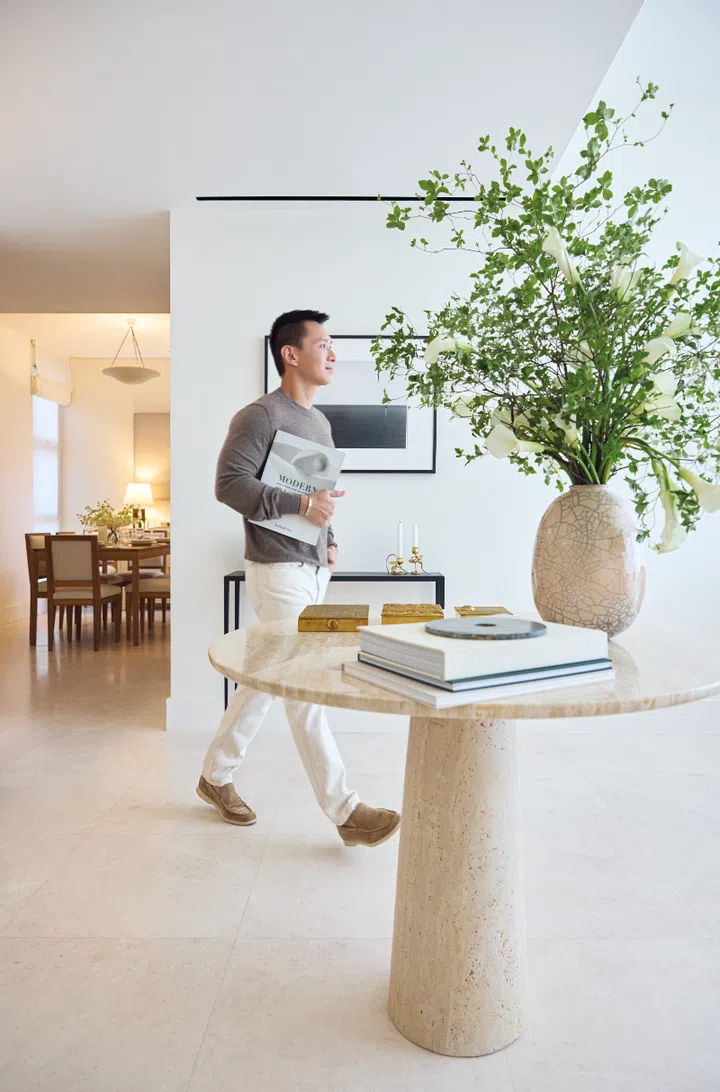 Andre Wu in his Dior sweater, APC trousers, Hermès leather bracelets, Cartier bracelet, and Loro Piana shoes.