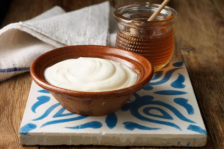 While this dairy product may not seem like the typical carb, the naturally occurring milk sugars (aka simple carbs) may scare some people away, but they shouldn't. This creamy snack can help you shed those unwanted pounds. Research has found that consuming probiotic yogurt (along with a low-calorie diet) can reduce your BMI and body-fat percentage. Low-fat Greek yogurt provides a powerful combination of natural sugar and satiating fat, along with protein. Lenchewski says, "the healthy fats and protein can prevent blood sugar levels from dropping, which will help keep sugar cravings at bay."