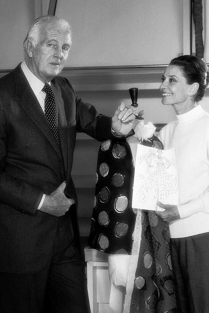 Givenchy and Hepburn pose together in the designer's Paris atelier.